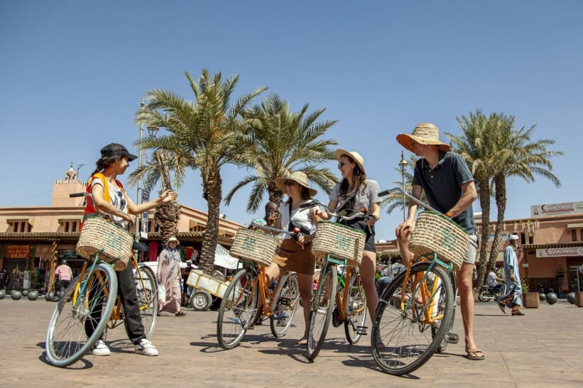 A group of 4 on bicycles with large wicker baskets