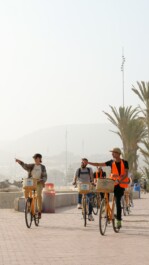 A group of cyclists ride along the beach in Agadir