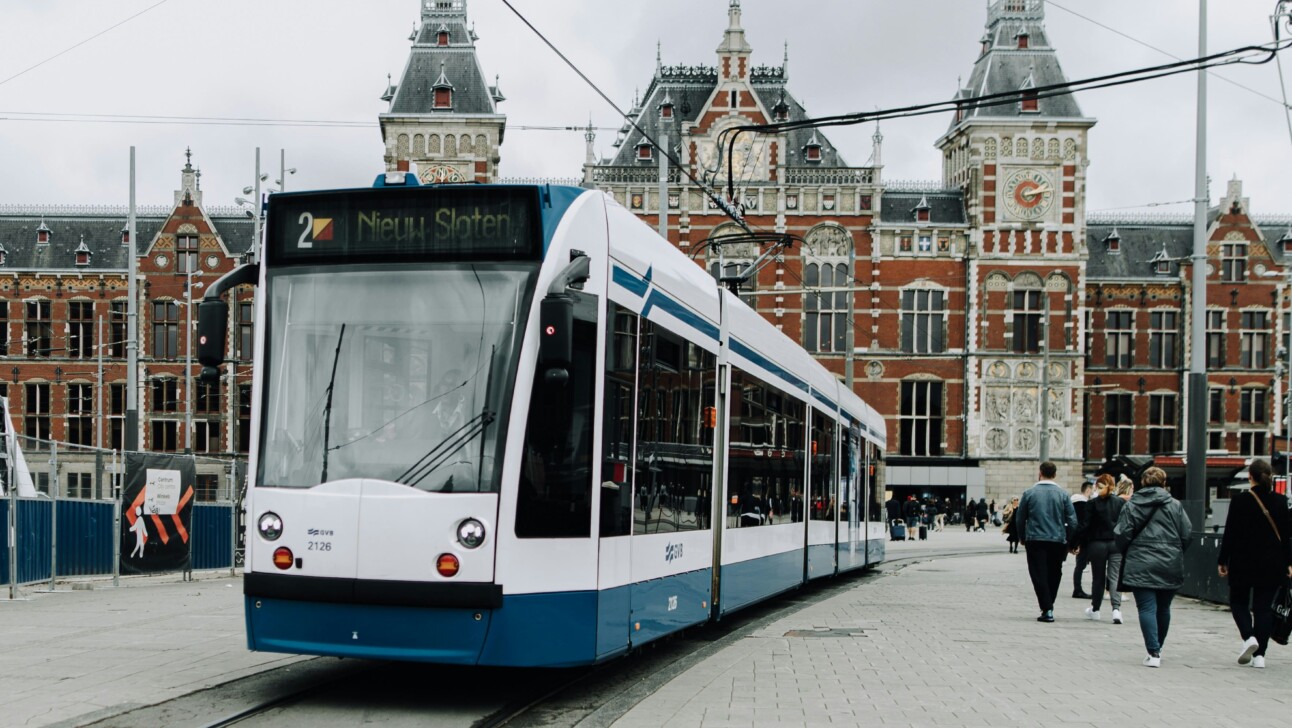 A tram goes by the Central Station in Amsterdam