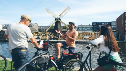 A guide points out a windmill in Amsterdam