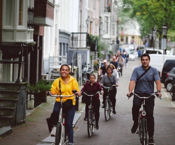 A group of cyclists ride through Amsterdam