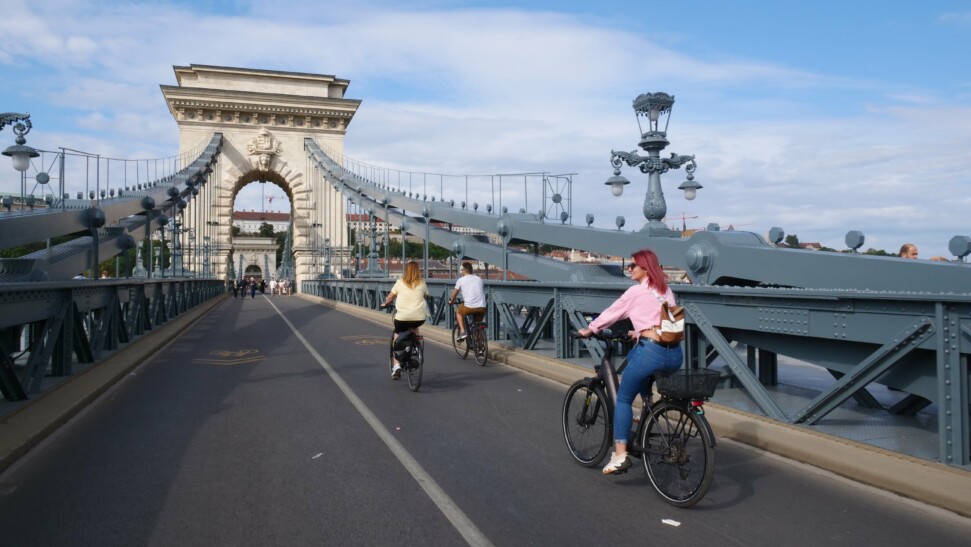 A group of cyclists cross the Széchenyi Chain Bridge in Budapest, Hungary