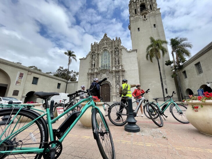 A group of cyclists stop in front of the Immaculata Church in San Diego