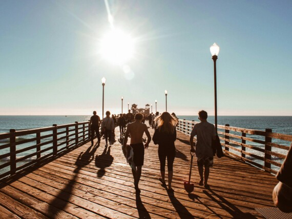 A group of people walking along the pier in San Diego