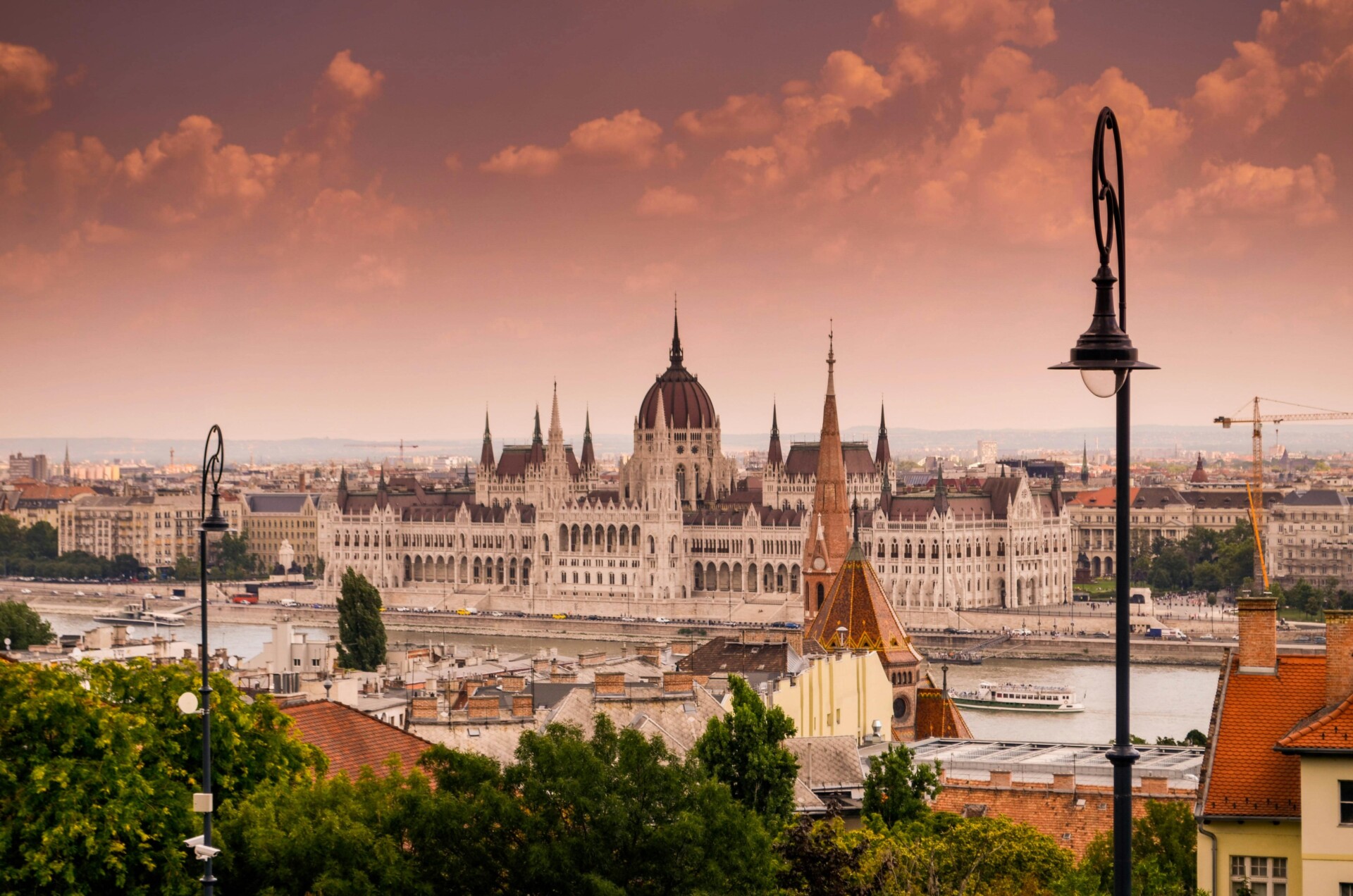 The city of budapest with a pink sky