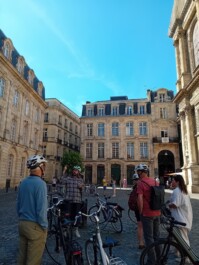 Cyclists stop outside a square in Bordeaux