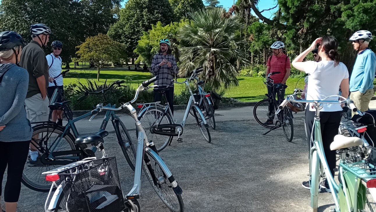 Cyclists stop outside the Jardin Public in Bordeaux