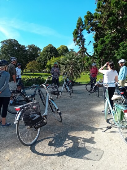 Cyclists stop outside the Jardin Public in Bordeaux