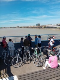 Cyclists stop along the river in Bordeaux