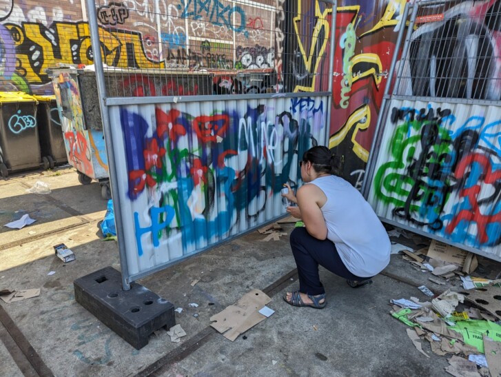 A man spray paints a temporary divider in Amsterdam